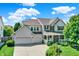 Charming two-story home with a well-maintained lawn, two-car garage, and inviting front porch at 16138 Palmyra Green, Westfield, IN 46074