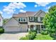 Charming two-story home with a well-maintained lawn, two-car garage, and inviting front porch at 16138 Palmyra Green, Westfield, IN 46074