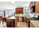 Bright kitchen with granite counters, wood cabinets, an island, and stainless steel appliances at 16138 Palmyra Green, Westfield, IN 46074