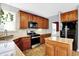 Kitchen with granite countertops, wood cabinets, stainless steel appliances, and tile flooring at 16138 Palmyra Green, Westfield, IN 46074