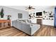 Comfortable living room featuring hardwood floors, a gray sofa, built-in shelves, and a fireplace at 16138 Palmyra Green, Westfield, IN 46074