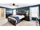 Spacious main bedroom featuring carpet, ensuite bathroom, blue accent wall, and two windows at 16138 Palmyra Green, Westfield, IN 46074