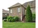 Mature trees and lush green grass surrounds the back of the home, with access to a deck at 16550 Gleneagles Ct, Noblesville, IN 46060