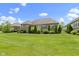 Spacious backyard with lush lawn, well-maintained landscaping, and a charming brick home at 16550 Gleneagles Ct, Noblesville, IN 46060