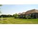 Expansive backyard with a pond and fountain surrounded by mature trees at 16550 Gleneagles Ct, Noblesville, IN 46060