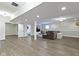 An expansive basement with light flooring, ample lighting, and a comfortable sitting area and an open doorway at 16550 Gleneagles Ct, Noblesville, IN 46060
