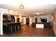 Spacious basement with a bar, dark wood features, and a connected living space at 16550 Gleneagles Ct, Noblesville, IN 46060