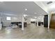 Basement presents an open layout with light flooring, pillars, seating, and a bar with a view of stairs at 16550 Gleneagles Ct, Noblesville, IN 46060