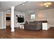 Finished basement living room with gray sectional, white built-ins, and a window view at 16550 Gleneagles Ct, Noblesville, IN 46060