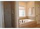 Bathroom featuring a tiled walk-in shower and a soaking tub with tile surround at 16550 Gleneagles Ct, Noblesville, IN 46060