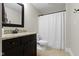 The bathroom boasts a dark wood vanity with granite countertop and a shower with a white curtain at 16550 Gleneagles Ct, Noblesville, IN 46060