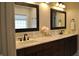 Bathroom featuring double sink vanity with marble countertop and framed mirrors at 16550 Gleneagles Ct, Noblesville, IN 46060