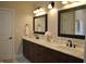 Elegant bathroom featuring double sink vanity with marble countertop and framed mirrors at 16550 Gleneagles Ct, Noblesville, IN 46060