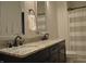 Bathroom featuring a double vanity with granite countertop and neutral colored shower curtain at 16550 Gleneagles Ct, Noblesville, IN 46060
