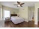 A well-lit bedroom features a ceiling fan, wood-look floors, neutral decor, and a cozy bed with a window desk at 16550 Gleneagles Ct, Noblesville, IN 46060