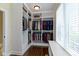 Large walk-in closet with custom shelving, hanging racks, ample storage space, and natural light from the window at 16550 Gleneagles Ct, Noblesville, IN 46060