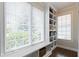 Bright closet with natural lighting, built-in shelves, drawers, and a window overlooking the outdoor scenery at 16550 Gleneagles Ct, Noblesville, IN 46060