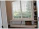 Walk-in closet area featuring window with blind, bench and custom shelving at 16550 Gleneagles Ct, Noblesville, IN 46060