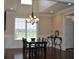 Bright dining room with hardwood floors, chandelier, and a view of the landscaped yard at 16550 Gleneagles Ct, Noblesville, IN 46060