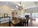 Dining room with dark wood floors, overhead chandelier and table at 16550 Gleneagles Ct, Noblesville, IN 46060