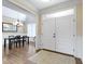 Bright entryway with hardwood floors, wainscoting, and a view of the dining area at 16550 Gleneagles Ct, Noblesville, IN 46060