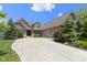 Beautiful brick home featuring a spacious driveway, manicured lawn, and mature trees at 16550 Gleneagles Ct, Noblesville, IN 46060