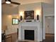 Beautiful fireplace with herringbone tile surround in a bright and airy living room at 16550 Gleneagles Ct, Noblesville, IN 46060