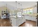 Modern kitchen features an island with bar seating, stainless appliances, and an open layout at 16550 Gleneagles Ct, Noblesville, IN 46060