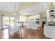Modern white kitchen with an island, stainless steel appliances, and seamless access to outdoor dining at 16550 Gleneagles Ct, Noblesville, IN 46060