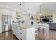 Bright open kitchen featuring a large island with granite countertops, stainless steel appliances, and hardwood floors at 16550 Gleneagles Ct, Noblesville, IN 46060