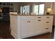 Kitchen island with seating, granite countertops, and white cabinetry at 16550 Gleneagles Ct, Noblesville, IN 46060