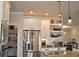 Bright kitchen featuring stainless steel appliances, granite countertops, and white cabinets at 16550 Gleneagles Ct, Noblesville, IN 46060