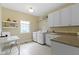 Bright laundry room with modern appliances, white cabinets, and ample counter space for folding and sorting at 16550 Gleneagles Ct, Noblesville, IN 46060