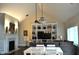 Bright living room with vaulted ceiling, built-in shelving, chandelier, fireplace and large window at 16550 Gleneagles Ct, Noblesville, IN 46060