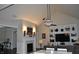 Open concept living room with vaulted ceiling, built-in shelving, fireplace and hardwood floors at 16550 Gleneagles Ct, Noblesville, IN 46060