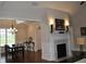 Open-concept living area features a fireplace and dining space with hardwood floors at 16550 Gleneagles Ct, Noblesville, IN 46060