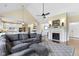 Open living room boasts a vaulted ceiling, fireplace, and seamless flow into a modern white kitchen at 16550 Gleneagles Ct, Noblesville, IN 46060