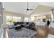 Spacious living room with an expansive window view and modern gray couch at 16550 Gleneagles Ct, Noblesville, IN 46060