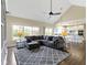 Spacious living room with vaulted ceilings, large windows, hardwood floors, and a comfortable gray sectional sofa at 16550 Gleneagles Ct, Noblesville, IN 46060