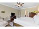 Well-lit main bedroom with hardwood floors, crown molding, neutral walls, and a television area at 16550 Gleneagles Ct, Noblesville, IN 46060