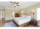 Bright main bedroom with hardwood floors, crown molding, neutral walls, and a view into the main bathroom at 16550 Gleneagles Ct, Noblesville, IN 46060