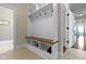 A functional mudroom features built-in storage with hooks and a bench, offering practical organization at 16550 Gleneagles Ct, Noblesville, IN 46060