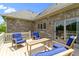 Outdoor patio with comfortable seating, including bright blue cushions, and a roof overhead at 16550 Gleneagles Ct, Noblesville, IN 46060