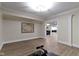 Recreation room has wood grain floors, neutral paint, and an open floor plan that leads to the living area at 16550 Gleneagles Ct, Noblesville, IN 46060