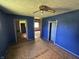 Bedroom features unfinished floors, blue paint, and is connected to other rooms at 1739 E 18Th St, Anderson, IN 46016