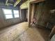 Bedroom with unfinished floors, exposed plumbing, and wall damage at 1739 E 18Th St, Anderson, IN 46016