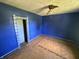 Bedroom features unfinished floors and a ceiling fan at 1739 E 18Th St, Anderson, IN 46016