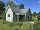 Charming home featuring weathered green siding, a gray roof, and a yard that needs tending at 1739 E 18Th St, Anderson, IN 46016