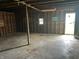 Garage with exposed framing, concrete floor, and a small window at 1739 E 18Th St, Anderson, IN 46016