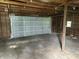 Spacious garage with a gray door and exposed framework at 1739 E 18Th St, Anderson, IN 46016